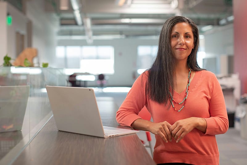 Woman standing at her work desk